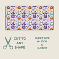 Tubie tape with a repeating cartoon ghosts, witches, pumpkins, moons, and spiderwebs on a light lavender background, shown with text indicating the sheet can be cut to any shape and dimensions 10cm by 20cm.