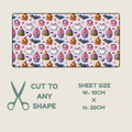 Tubie tape shown on a beige background, with text below reading 'CUT TO ANY SHAPE', 'SHEET SIZE W-10CM X H-20CM', and a scissors icon. The sheet has a pastel lavender base with a repeating Halloween print including ghosts, pumpkins, cupcakes, bats, and hearts.