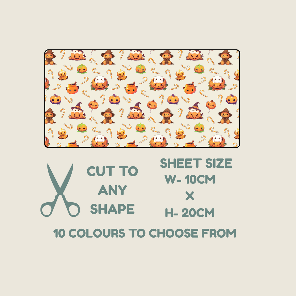 A tubie tape swatch showing a repeating Halloween-themed print with pumpkins, ghosts, and candy corn on a light cream background. Below the swatch, text reads 'CUT TO ANY SHAPE', 'SHEET SIZE W-10CM x H-20CM', and '10 COLOURS TO CHOOSE FROM', with a scissors icon on a pale beige background.