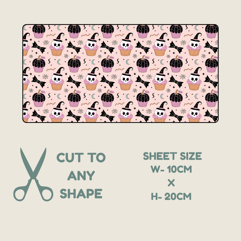 Tubie tape with a Halloween design, shown on a light beige background with text indicating it can be cut to any shape and the sheet size is 10cm by 20cm. The pattern features pink and black cupcakes with skull faces, black cacti wearing witch hats, black bats, and small black bats on a pale pink background.