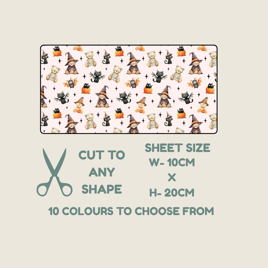 A product information graphic showing a rectangular sample of a repeating Halloween-themed pattern with teddy bears, witches, pumpkins, and black cats on a pale pink background. Below the sample, text reads 'CUT TO ANY SHAPE', 'SHEET SIZE W- 10CM x H- 20CM', and '10 COLOURS TO CHOOSE FROM', with a teal scissors icon on a light warm-gray background.