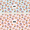 Two Halloween-themed repeating pattern swatches labeled #1 and #2. The top pattern (#1) has a light blue background with orange, purple, and brown spooky treats like cupcakes, ghosts, and spiders.
the bottom #2 has a light pink background with orange, purple, and brown spooky treats like cupcakes, ghosts, and spiders.