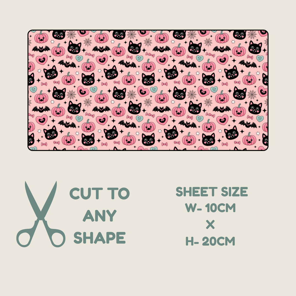 Tubie tape shown on a light beige background, with text below reading 'CUT TO ANY SHAPE', 'SHEET SIZE W-10CM x H-20CM', and a scissors icon. The sheet has a pink Halloween-style print with black cat faces, pumpkins, bats, and small decorative motifs.