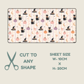 Hypoallergenic tubie tape with a Halloween-themed print of black cats, pumpkins, witch hats, and moons on a cream and pink striped background, shown with text indicating sheet size 10cm x 20cm and the option to cut to any shape.