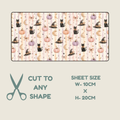 A rectangular tubie tape with a repeating Halloween-style print of black cats, pumpkins, witch hats, and crescent moons on a pale pink striped background, shown with text reading 'CUT TO ANY SHAPE' and 'SHEET SIZE W-10CM x H-20CM' on a light beige background.
