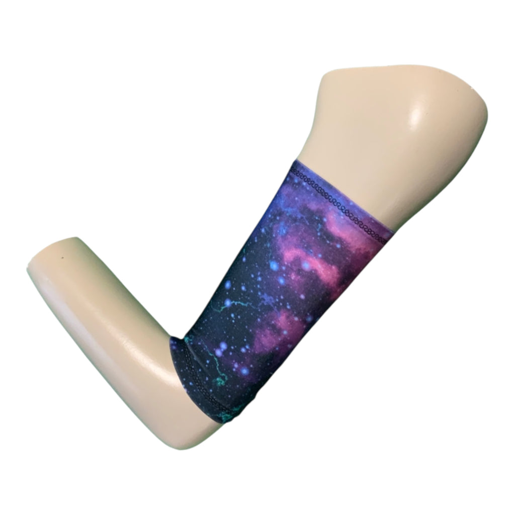 Picc line cover with a galaxy print in blues,purples, and pinks. Displayed on a mannequin arm.