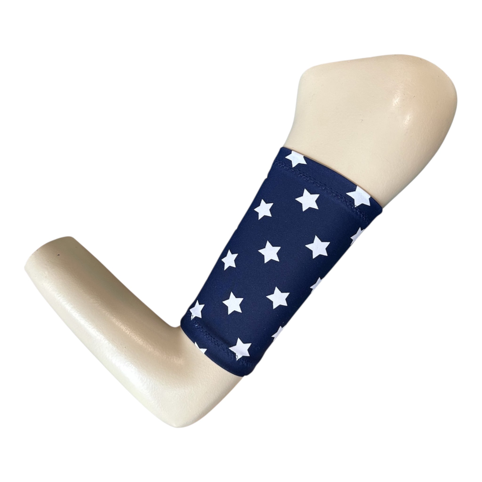 A nay blue picc line cover with white star print. The armband is displayed on a manequinn arm.