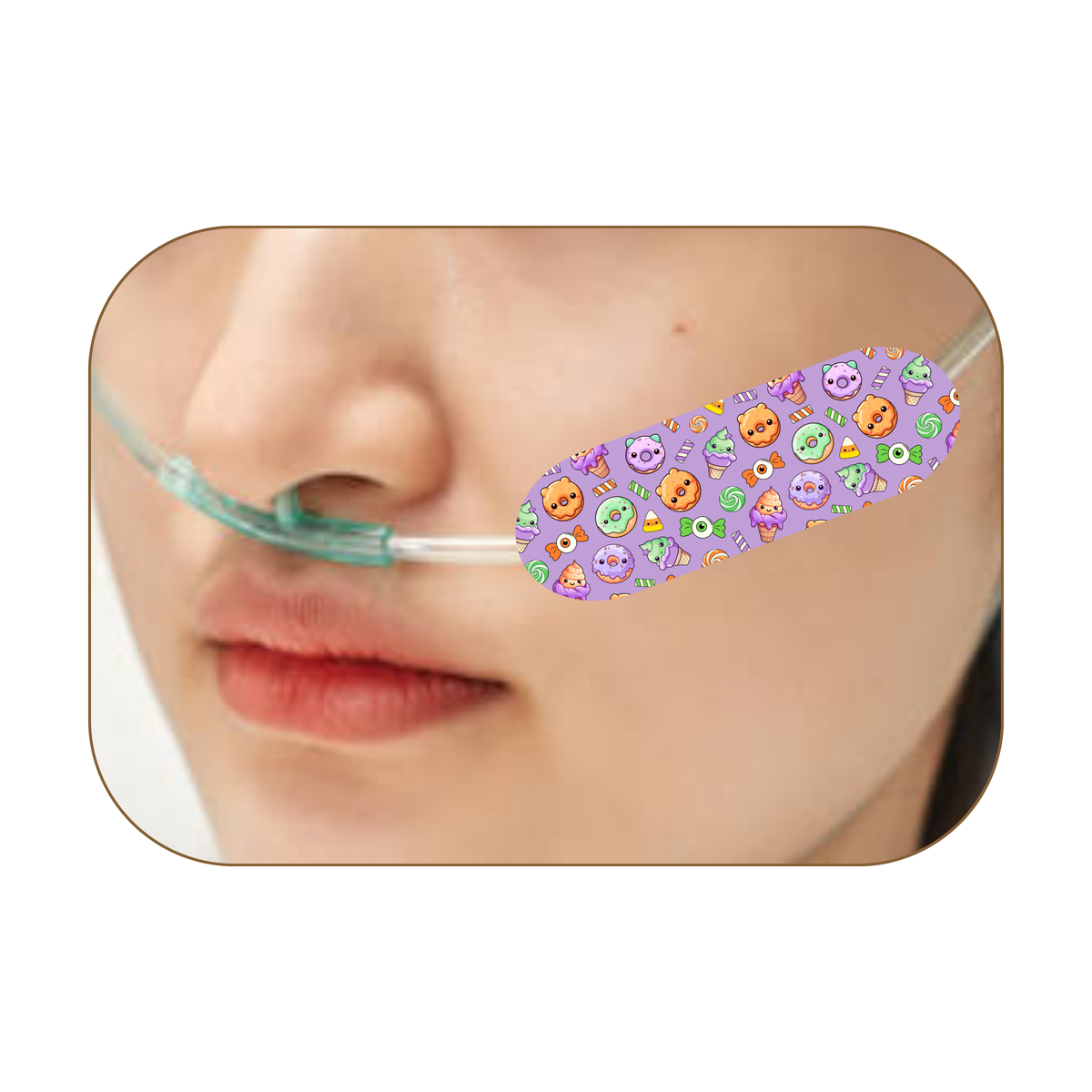 A close-up of a person's face wearing a purple nasal oxygen tube with a colorful Halloween-themed pattern of pumpkins, ghosts, and spiders on the tube.